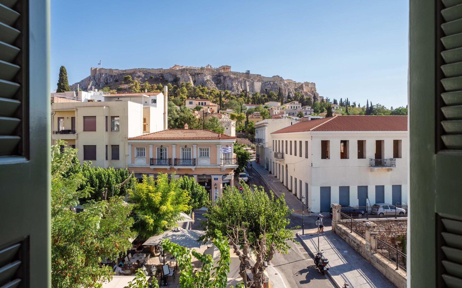 The Acropolis above the rooftops of Plaka, framed by green shutters at The Aeolian