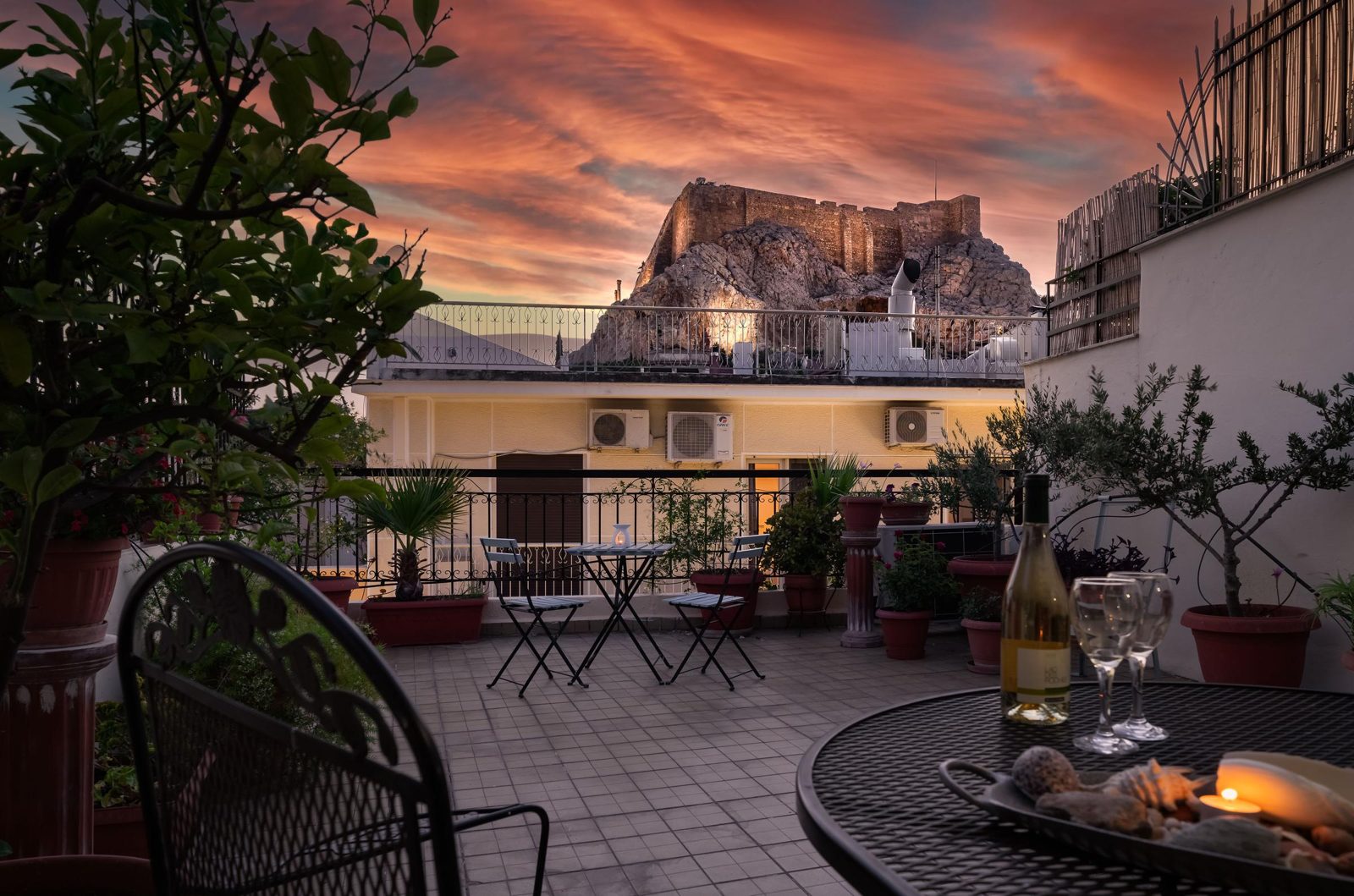 The Acropolis behind a terrace with plants at sunset, at Villa127